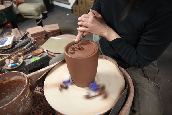 4 Trim excess clay out of the canister’s bottom, leaving behind a tall foot ring.