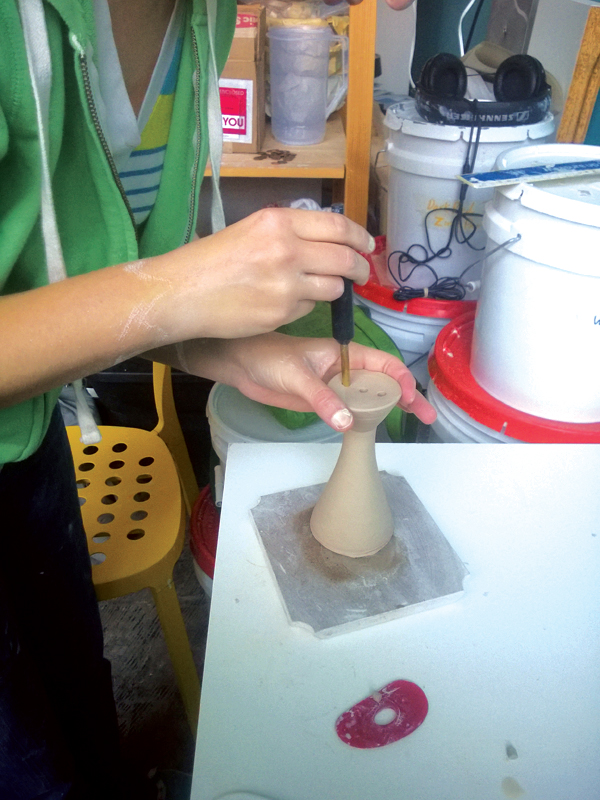 4 Attach a slab to the spout, let it stiffen up, then punch holes for water to flow through.