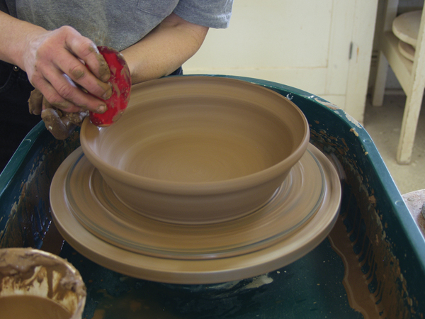 1 Create a 10-inch wide bowl with a slight curve where the floor meets the wall. Pull out the top -inch to create a gallery.