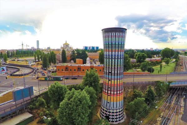 1 Aerial view of the Torre Arcobaleno (Rainbow Tower) in Porta Garibaldi, Milan, Italy. The recently restored surface is covered in 100,000 ceramic tiles and the multi-colored Rainbow Tower anchors a new development zone in the city.