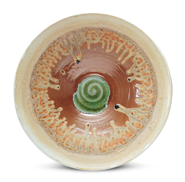 Jared Zehmer used a dowel to achieve the final diameter (11½ in. (29 cm)) of the bowl without having it slump or collapse. After the bisque firing, he glazed the bowl with reduction and ash glazes, laid a piece of green bottle glass in the center to emphasize the throwing texture, then fired it to cone 10 reduction in a gas kiln.