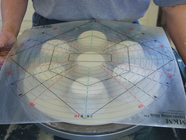 3 Arrange cups on the underside of the slab. Use a decorating disk to space them evenly.