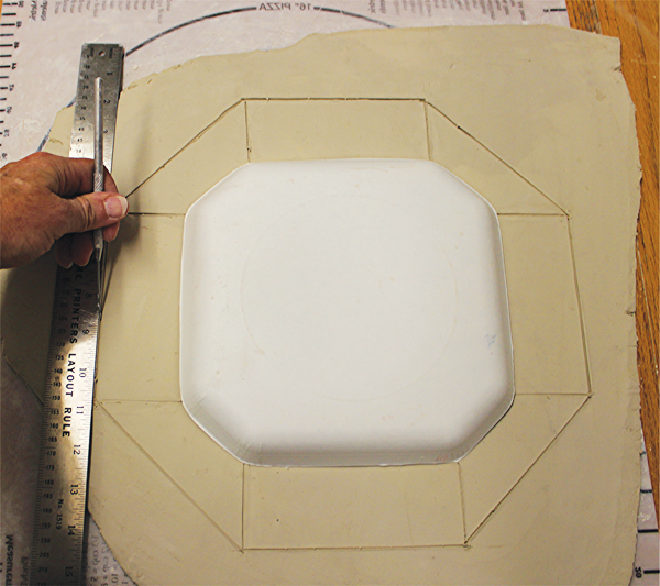 1 Draw a border around the plate. Use a straight edge and an X-Acto to cut it out.