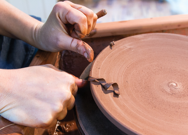 4 Use a wire tool to cut and soften the rim of the plate. Trim a foot on the plate once it’s leather hard.