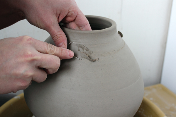 4 Trim the exterior surface to reveal the groggy texture of the stoneware.