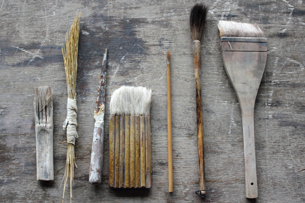 A Handmade and commercially-bought tools and brushes used for slip decoration.