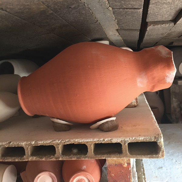 11 Load the pitcher in the train kiln on it’s side sitting on three seashells.