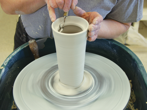 1 Make two round-shaped notches opposite each other on the rim’s gallery. Smooth and refine the cut out areas.