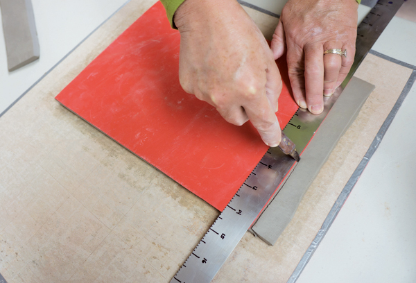 1 When cutting the template on the short sides, hold the knife at an angle to create an even bevel join and a smooth seam.