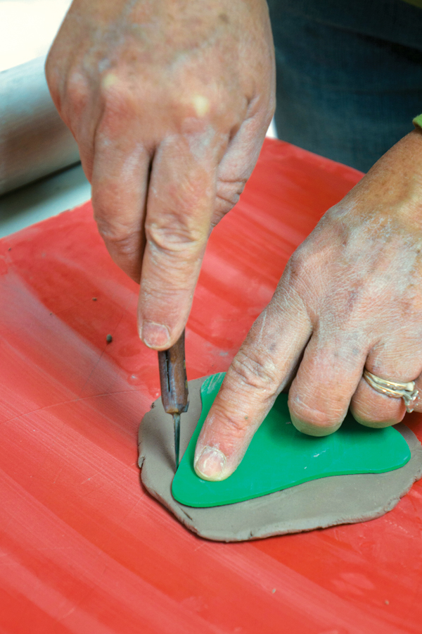 12 Using a pear-shaped template, cut a spout from a 1⁄8-inch-thick slab. Texture one side of the slab if you wish.