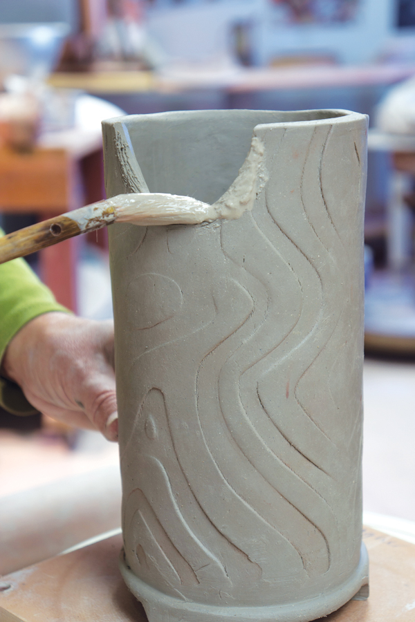 13 Score and slip the joining edge then add the spout. Use slip made from the same clay body as the form is made from.