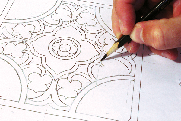 2 Drafting the Flores tile using both plastic templates and freehand drawing.