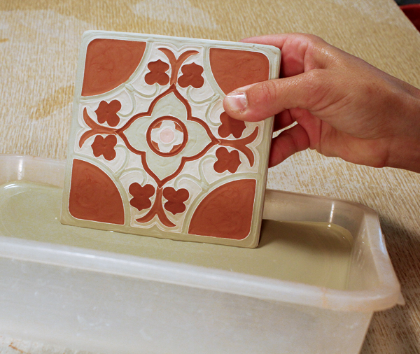 12 Once the bulb-syringe-applied glazes are fully dry, dip the edges on all sides in a tray of glaze prior to the final glaze firing.