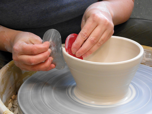 1 With 2 ribs, open a thrown bowl to widen the rim and clean up any throwing lines.