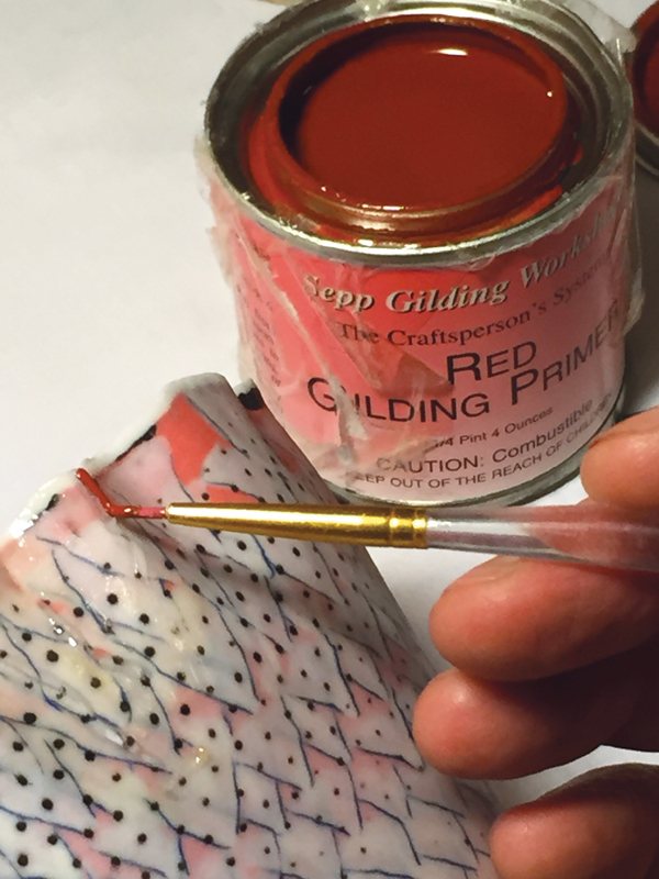 3 Apply red gilding primer onto the epoxied area, but not on the frisket.