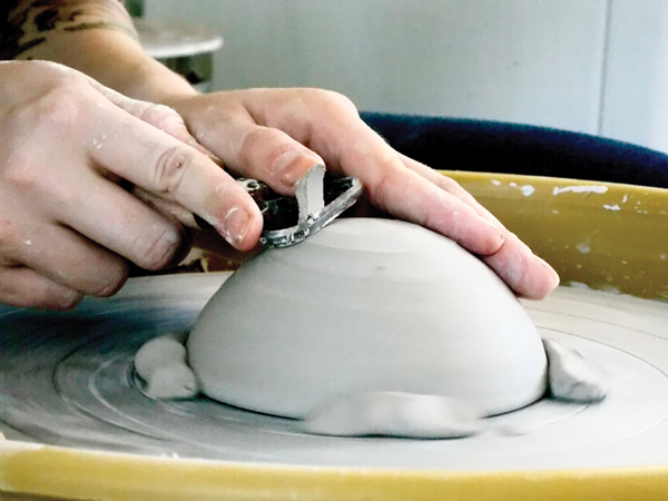 8 Once the bowl reaches soft leather hard, trim it to have a rounded bottom.
