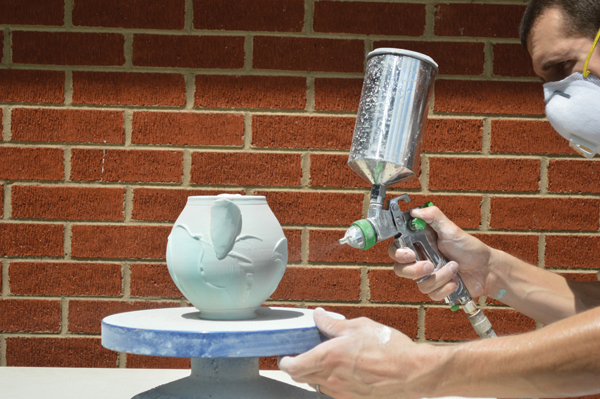 10 I spray my pots with a matte, micro-crystalline glaze. Hold your spray gun 8–10 inches away from the pot, moving it in a circular motion as you turn the banding wheel.