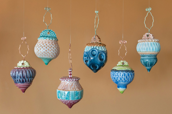 A variety of wheel-thrown ornaments. Each piece employs carving, stamping, and handbuilding techniques along with brushed and dipped studio-made glazes. Photo: Tony Drehfal.