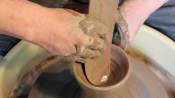 3 Open up the bottom just enough to fit the tool. Always keep the rib wet when applying it to the clay surface.