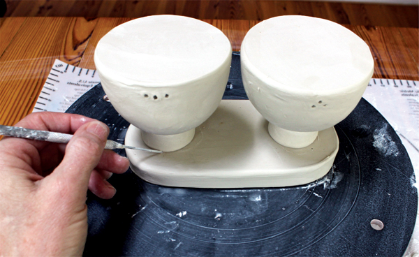 11 Space and center the shakers on the slab. Trace around the salt and pepper shaker feet, then remove the shakers.