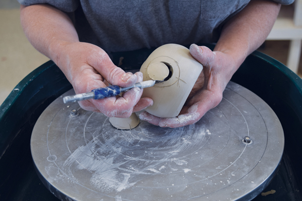 10 Place the spout on the pot so that its lower edge is slightly below the top of the pot. Mark a line, then cut a hole.