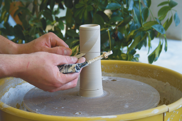 1. After horizontally marking the start and the finish lines of the pattern, begin faceting the cylinder with diagonal cuts from the top line down and then from the bottom line up. 