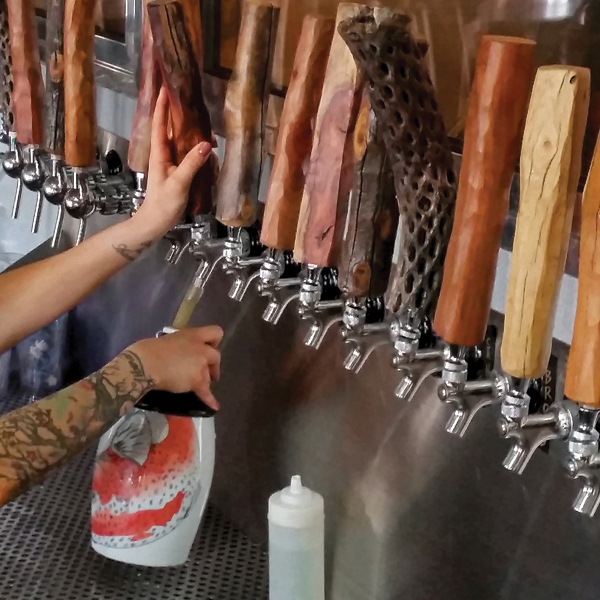 Brad Klem’s growler, Redfish (porcelain, ceramic decal, china paint), being filled at Wilderness Brewing Co. in Mesa, Arizona.