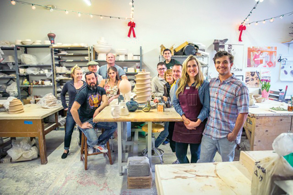 1 Samantha and Sutter Stremmel along with some of the 60 artist members who work together in the studio.