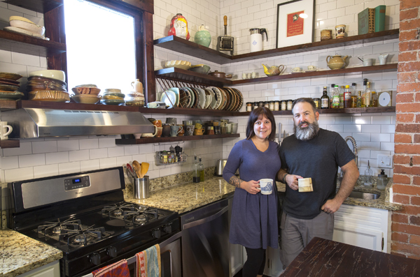 1 Tiffany Carbonneau and Brian Harper in their kitchen in New Albany, Indiana, holding mugs by Nicole Aquillano and Mark Arnold, respectively.