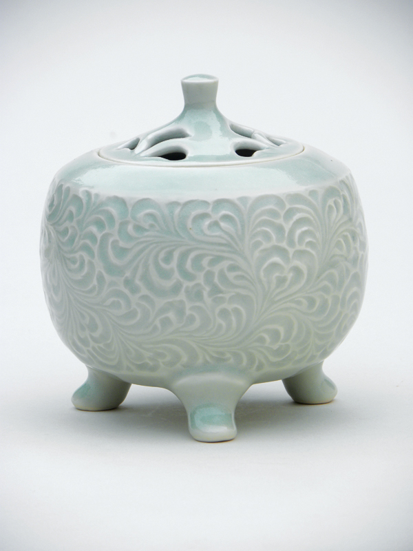 8 Incense burner, 5 in. (13 cm) in height, porcelain, carved Japanese karakusa mon (Japanese arabesque pattern), pale celadon glaze.