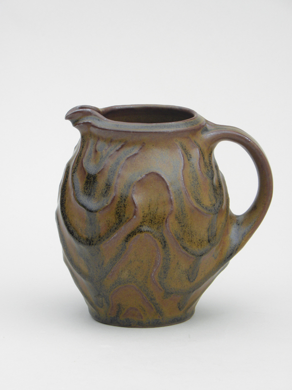 5 Small carved pitcher, iron-saturated glaze, iron oxide, and clear glaze over washes. Interactions between the base glaze and the washes create visual change and depth.