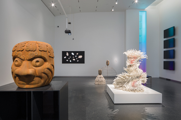 1 Foreground (left to right): Nathan Mabry’s Shapeshift (Snake), 6 ft. (2 m) in height, terra cotta, aluminum, Plexiglas, stainless steel, paint, 2013. Zemer Peled’s New Year’s Best Dreams, 4 ft. (1 m) in height, clay and metal, 2015. Background (left to right): Mika Negishi Laidlaw, Dave Ryan, and Steven Ryan’s Vigilants, cast porcelain, video art technology. Simone Leigh’s Cowrie (Sage), 36 in. (91 cm) in height, terra cotta, porcelain, sage, string, wire, steel, 2015. Simone Leigh’s Cowrie (Pannier), 5 ft. (1.5 m) in height, terra cotta, porcelain, steel, 2015. Background (right wall): Ben Harle’s Moments of Impact, video.