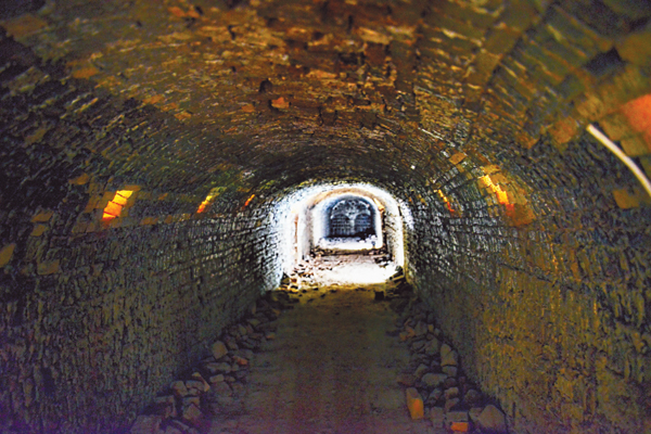 View of the kiln interior, looking toward tow of the side openings used to load the kiln. Stoking holes can be seen along the length.