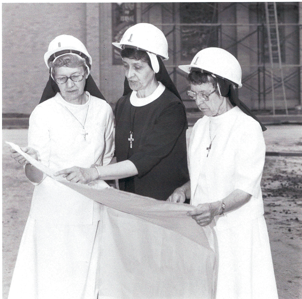 Sister Agnita Ganzel, Sister Jane Mary Sorosiak, and Sister Helen Chumura reading the blueprints for the Franciscan Center, 1983.