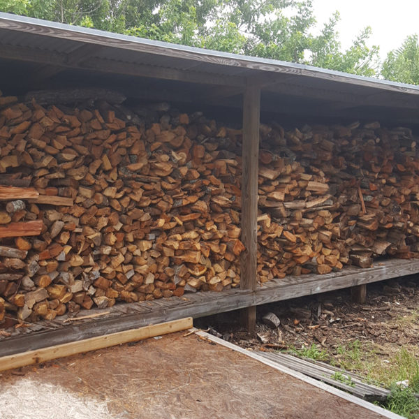 4 Wood shed at Morean Center for Clay stocked with free wood from the city dump, cut to size for stoking.