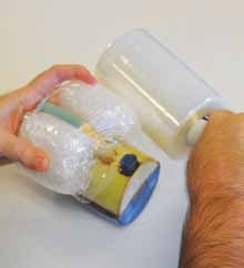 2 Small squares of bubble wrap folded and secured in place with stretch wrap protecting the handle of Marty Fielding’s cup.
