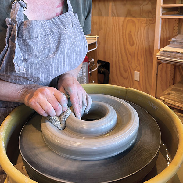 2 Press down in the center of the band to split the clay. Stop 1/3 inch from the bat.